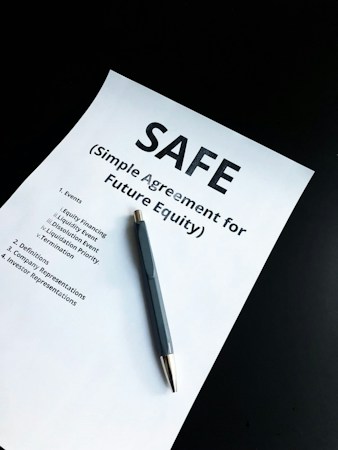 Person signing a document with a pen, like a Las Vegas renter reviewing and signing a lease renewal