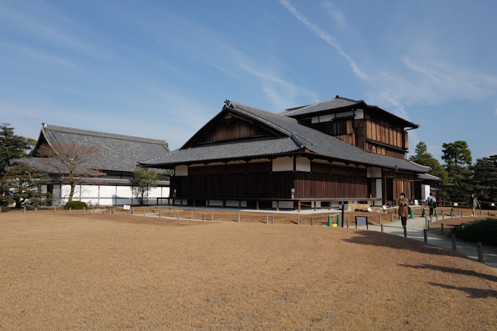 a large wooden building sitting on top of a dry grass field