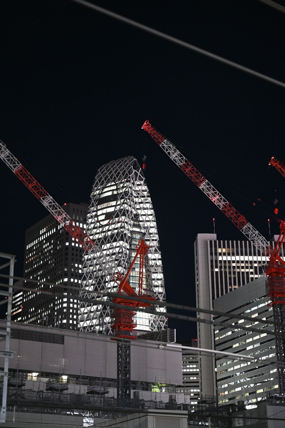 a group of cranes that are standing in the air