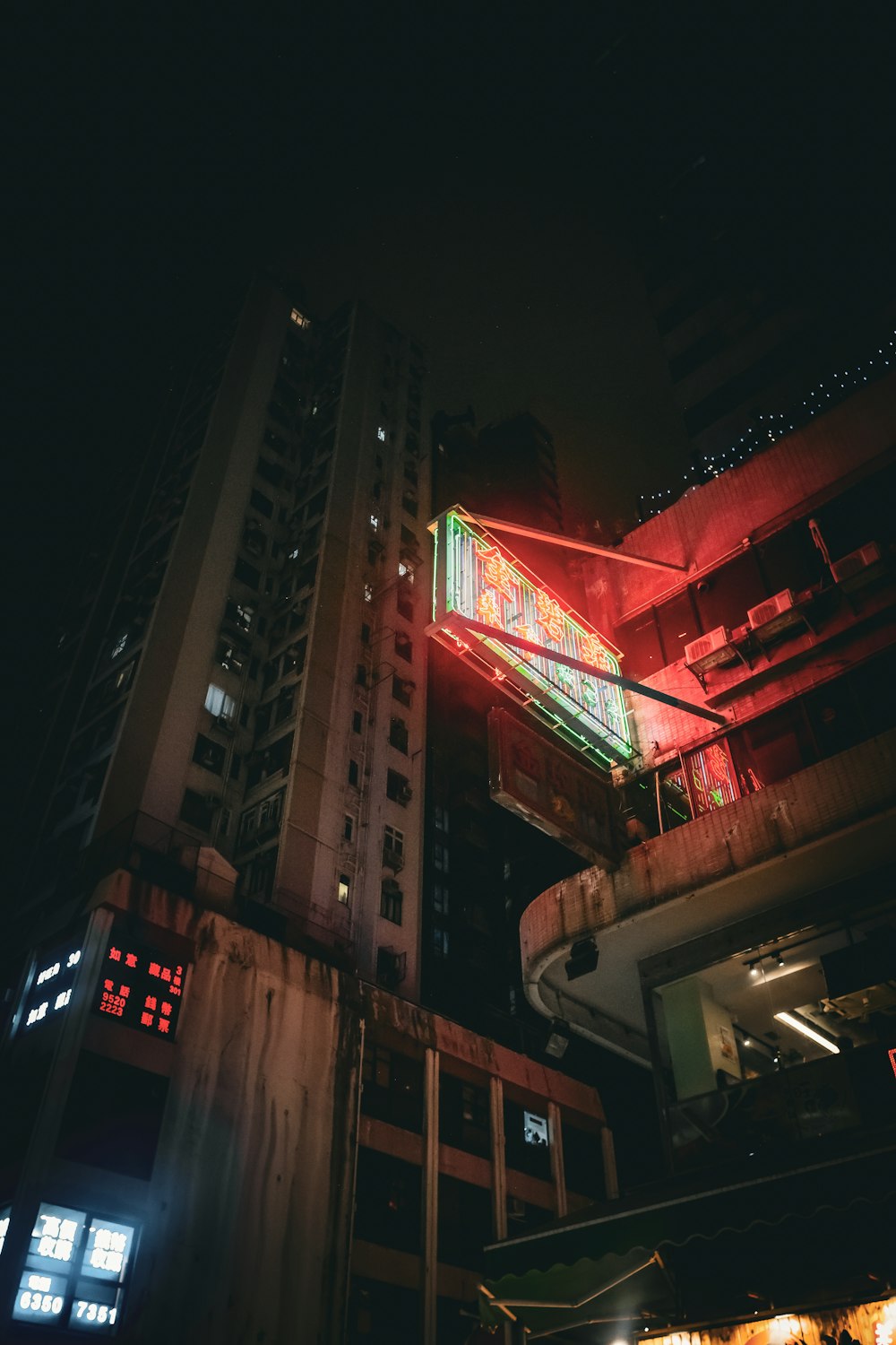 a building with a neon sign in the middle of it