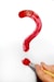 a hand holding a paintbrush and a red question mark