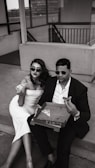 a man and a woman sitting on the steps of a building