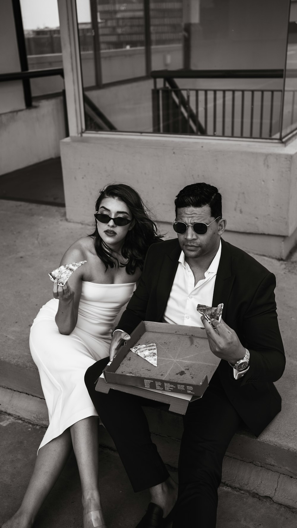 a man and a woman sitting on the steps of a building