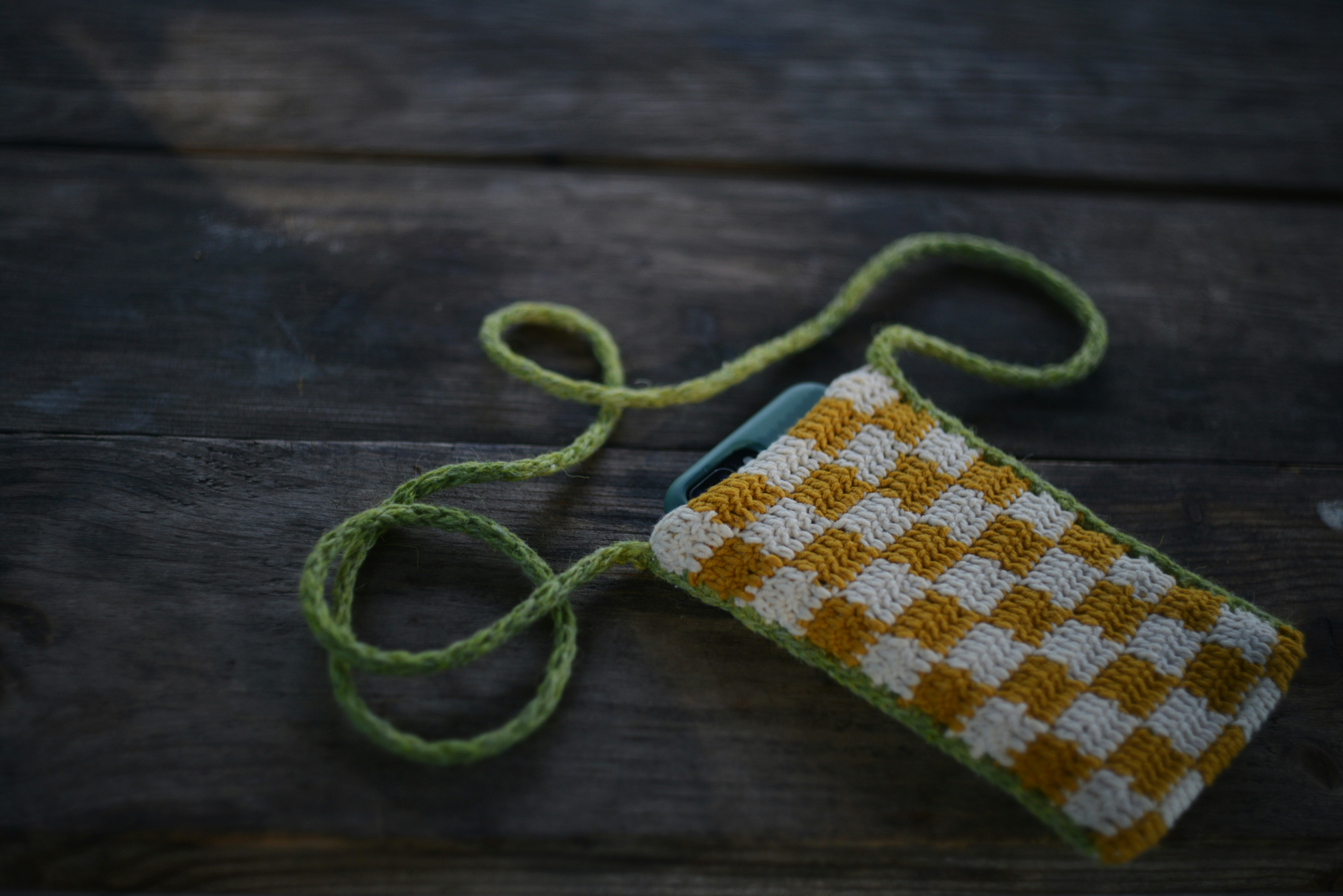 an orange and white checkered bag on a wooden table