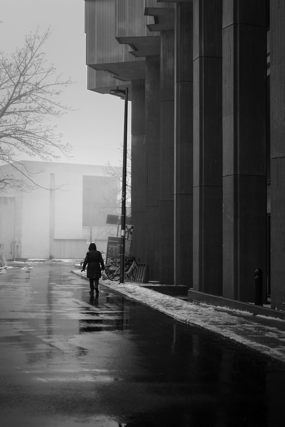 a person walking down a street in the rain