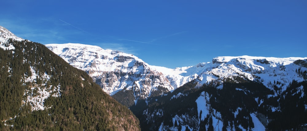 a mountain range with snow covered mountains in the background