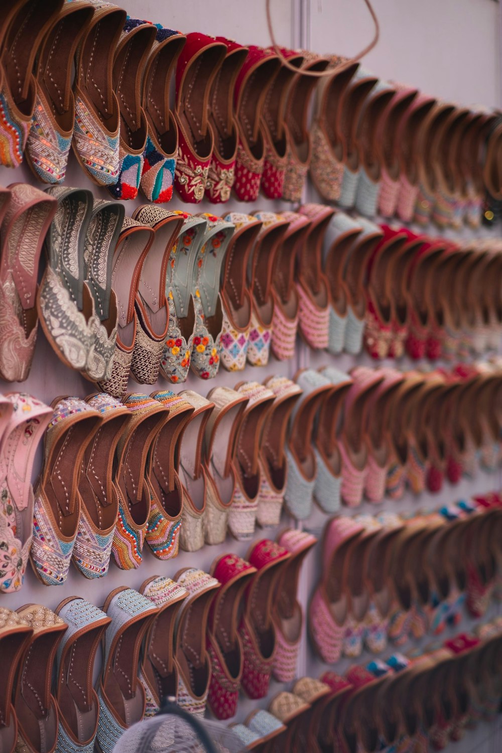 a wall full of shoes hanging on a wall