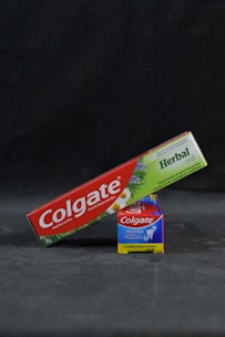 colgate toothpaste and tooth paste on a black background