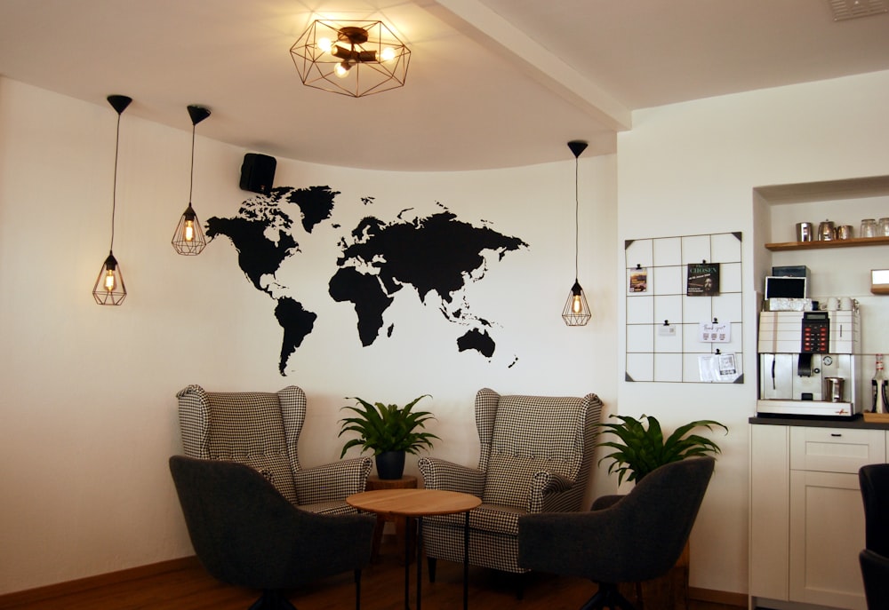 a living room with two chairs and a map on the wall