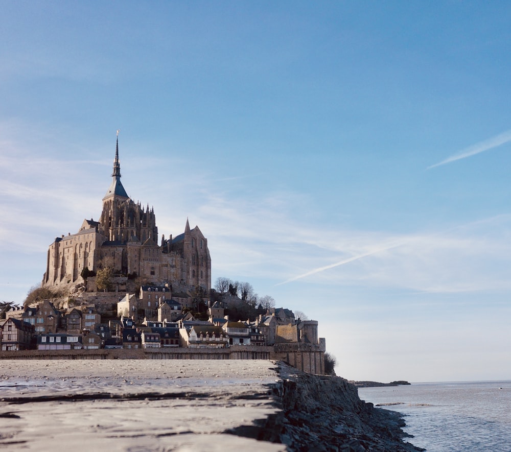 a large castle sitting on top of a beach next to the ocean