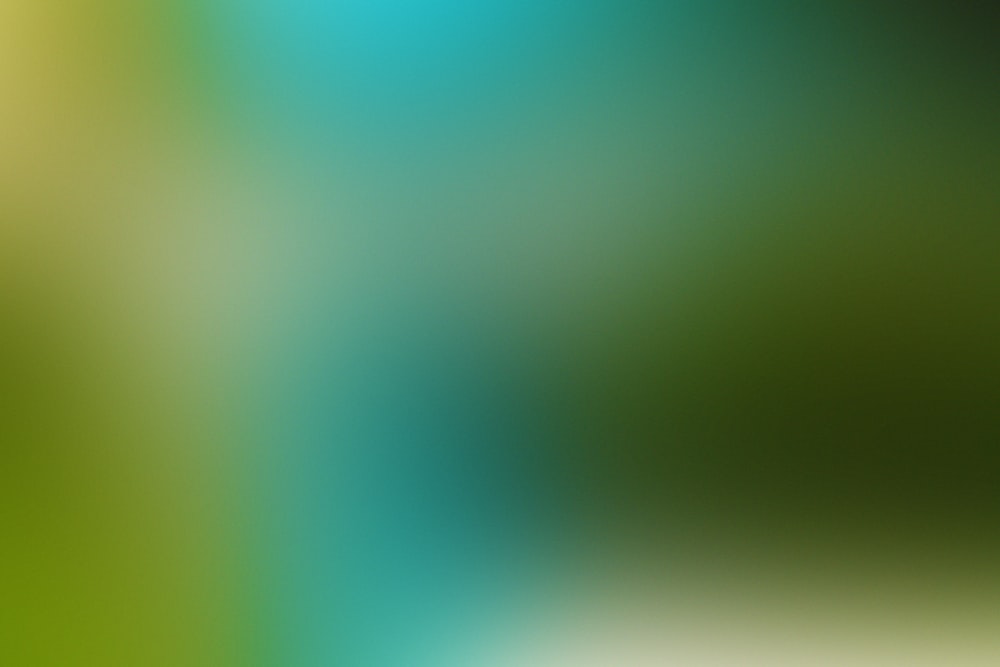 a blurry image of a green and blue background