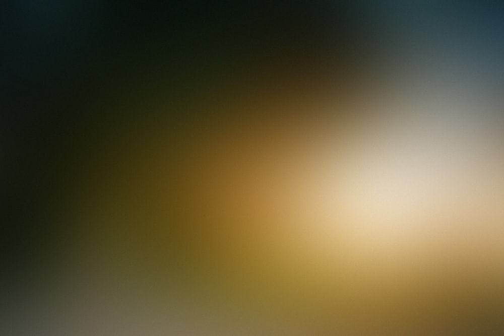 a blurry image of a yellow and blue background