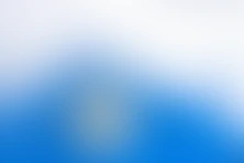 a blurry blue and white background with a white background