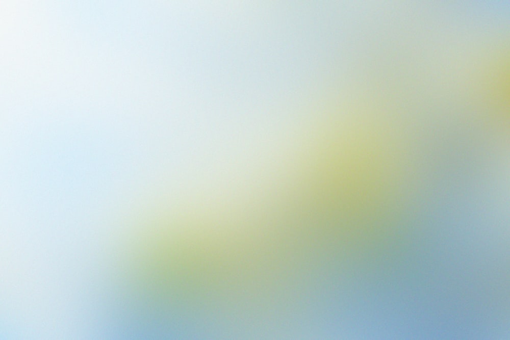 a blurry image of a yellow and blue background