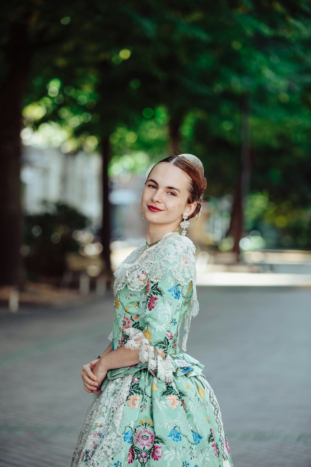 a woman in a floral dress poses for a picture