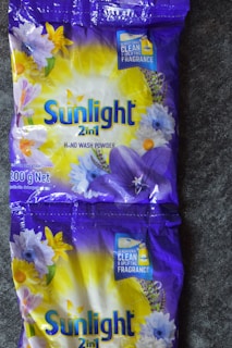 two bags of sunlight all deterant sitting on a floor