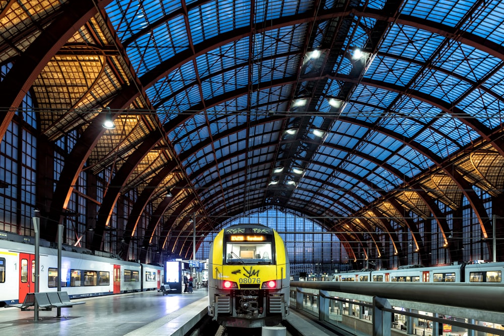 a yellow train is pulling into a train station