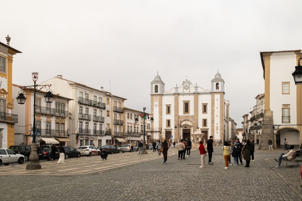 a group of people walking down a cobblestone street