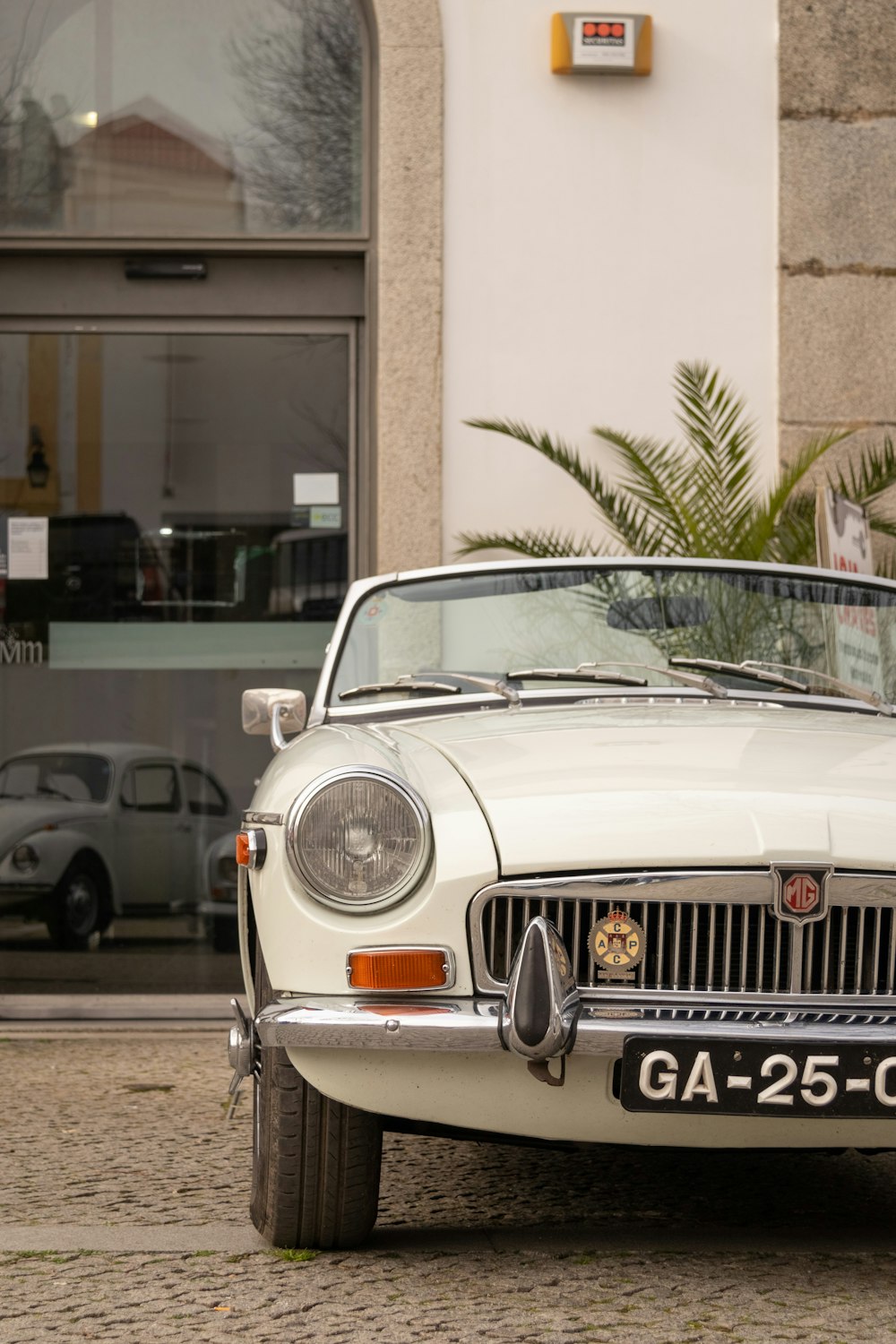 a white car parked in front of a building