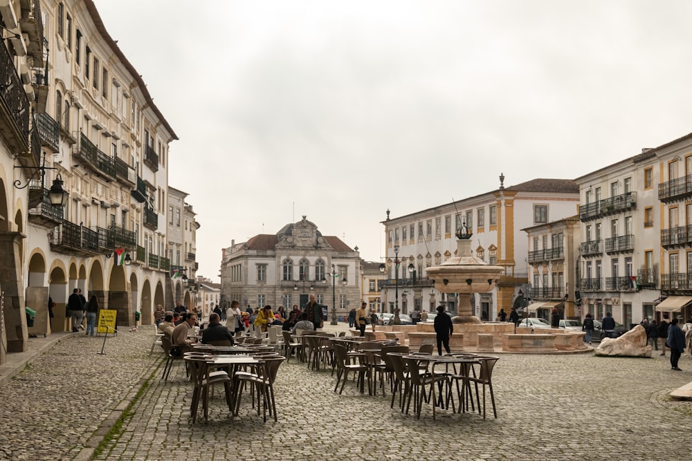 a cobblestone street lined with tables and chairs