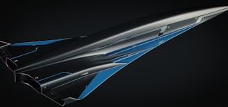 a blue and black jet flying through a dark sky