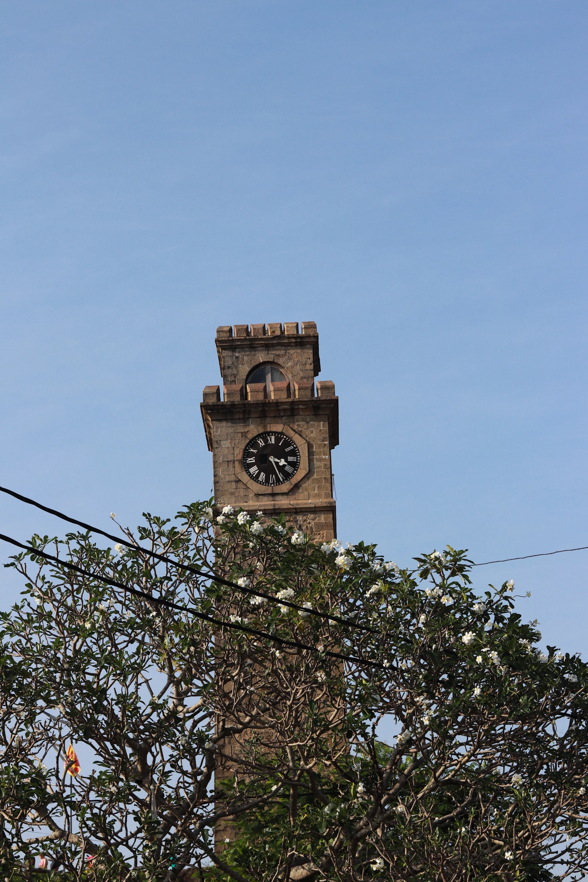 a tall clock tower with a clock on each of it's sides