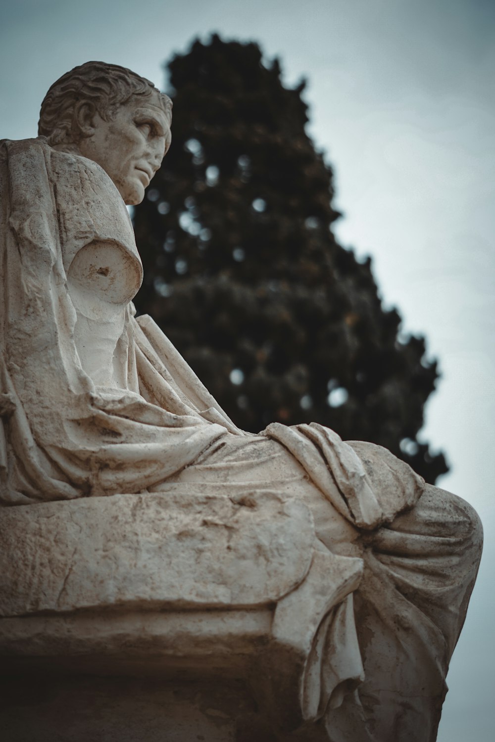 a statue of a woman sitting on a bench