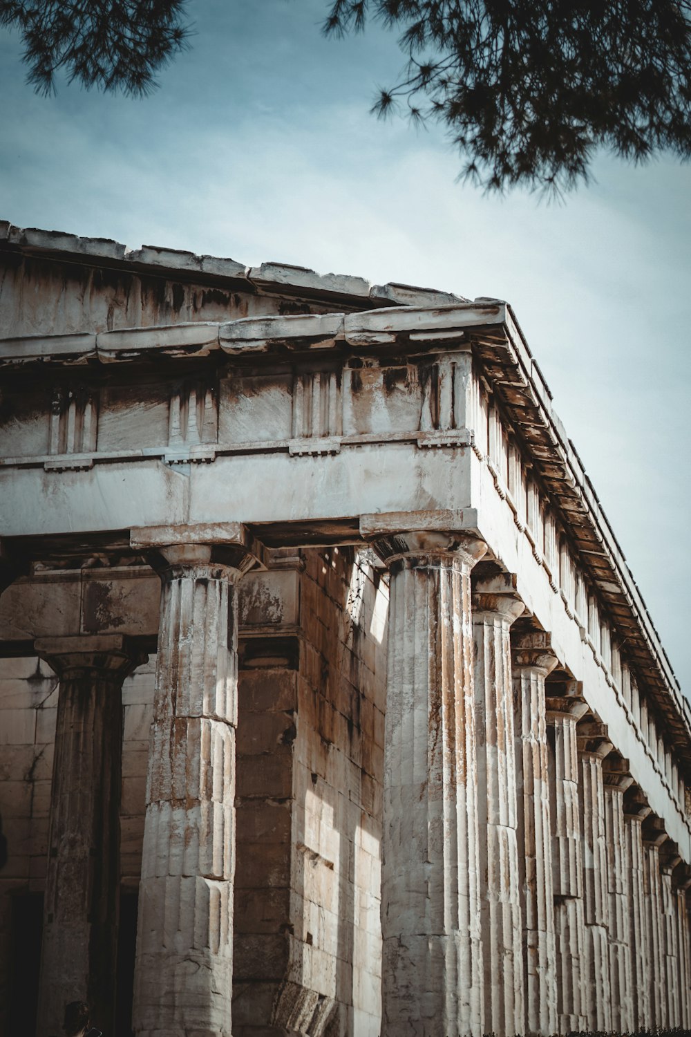 an old building with columns and a sky background