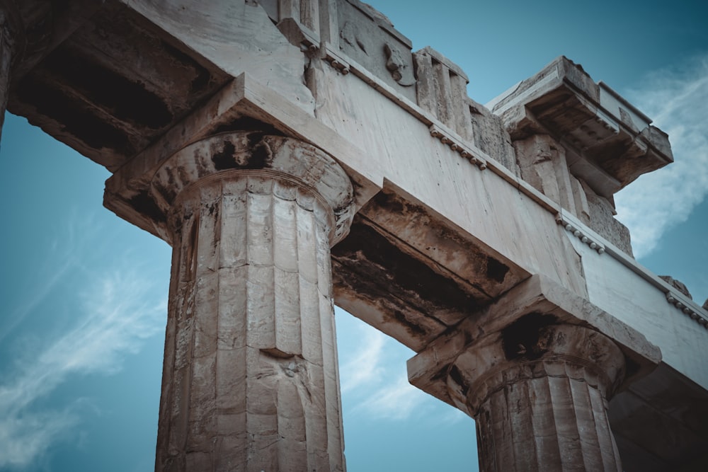 a close up of a stone structure with columns