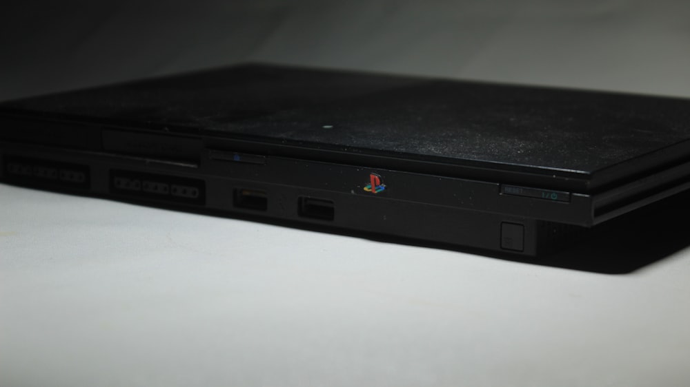 a black laptop computer sitting on top of a white table