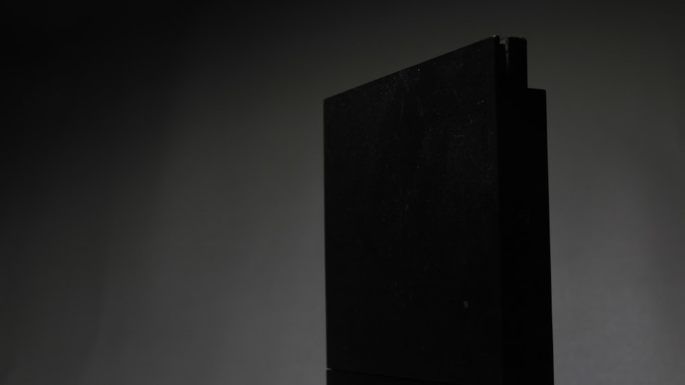 a black piece of furniture against a gray background