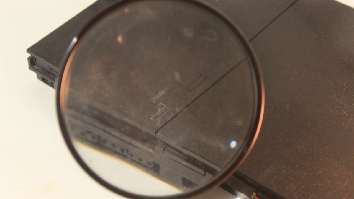 A person holding a magnifying glass — representing investigation and close examination of evidence