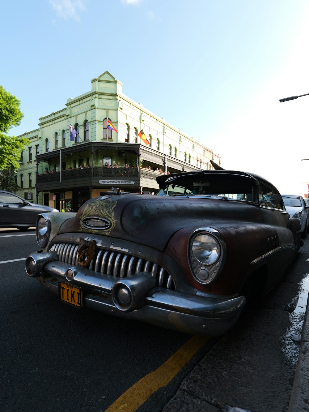 an old car parked on the side of the road