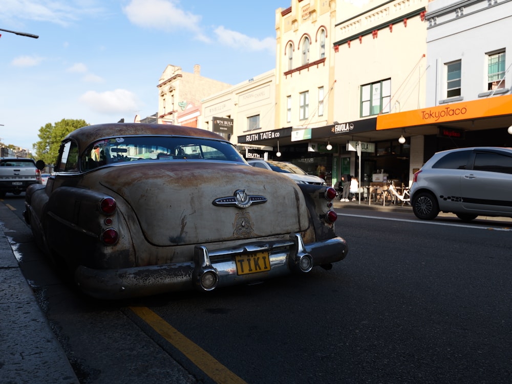 an old car parked on the side of the road