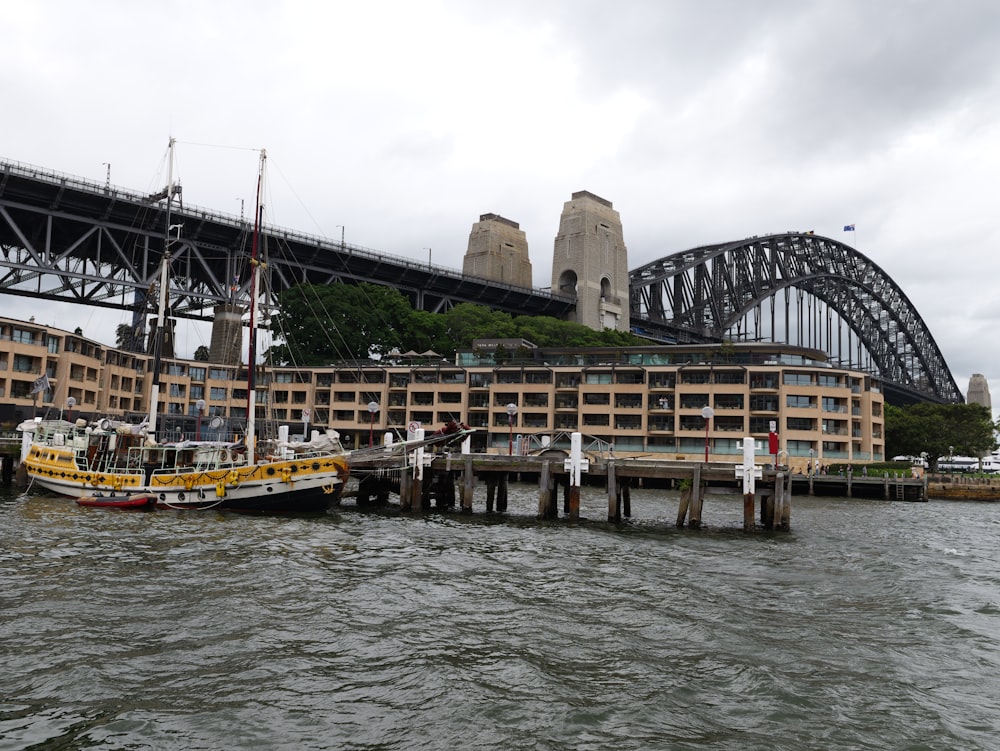 two boats are docked in front of a large building