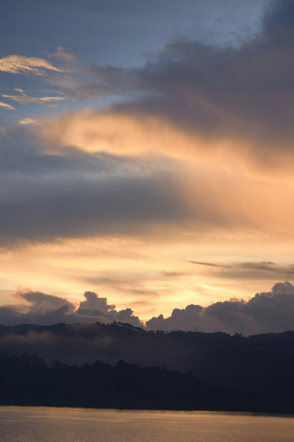 a large body of water under a cloudy sky