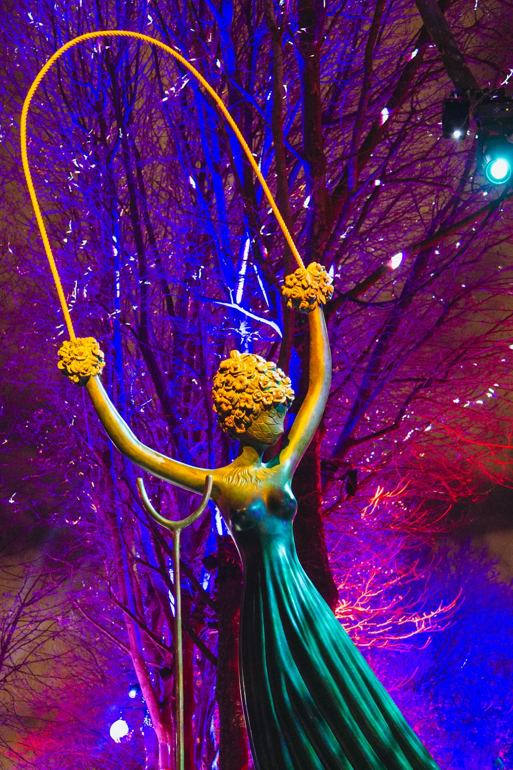 a statue of a woman holding a hula hoop