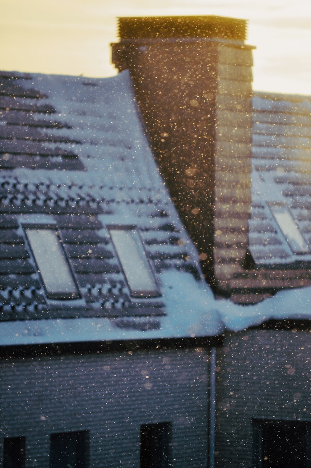 a snow covered roof with a building in the background