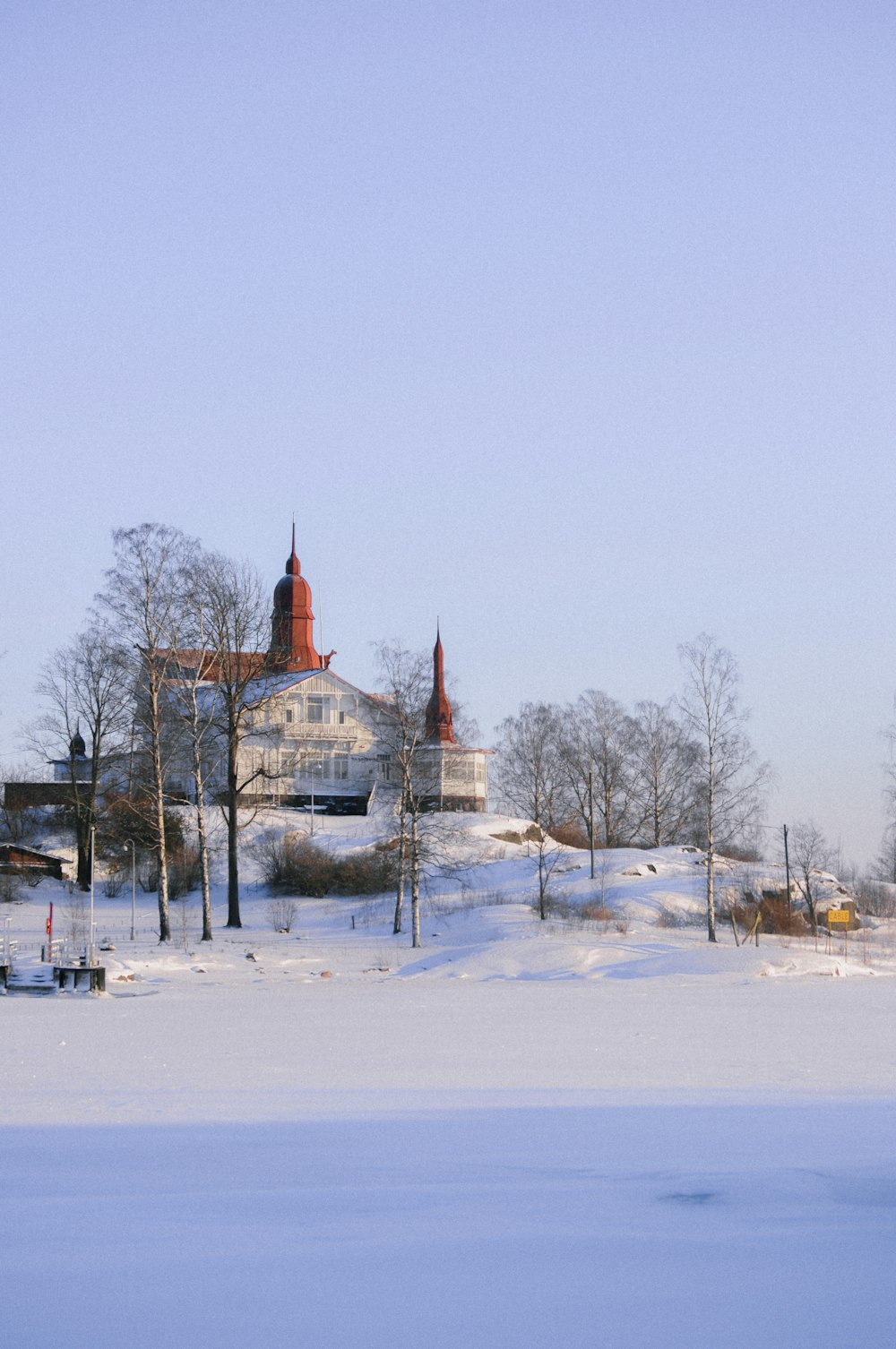 a large white building sitting on top of a snow covered field