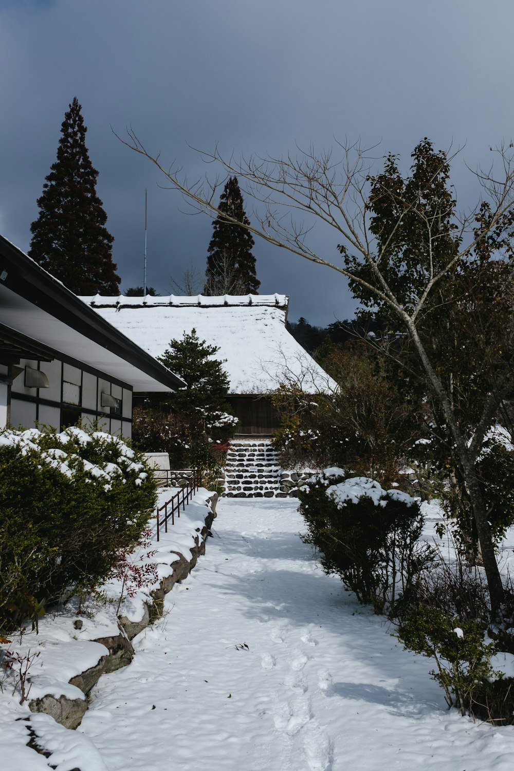 a snow covered path leading to a building