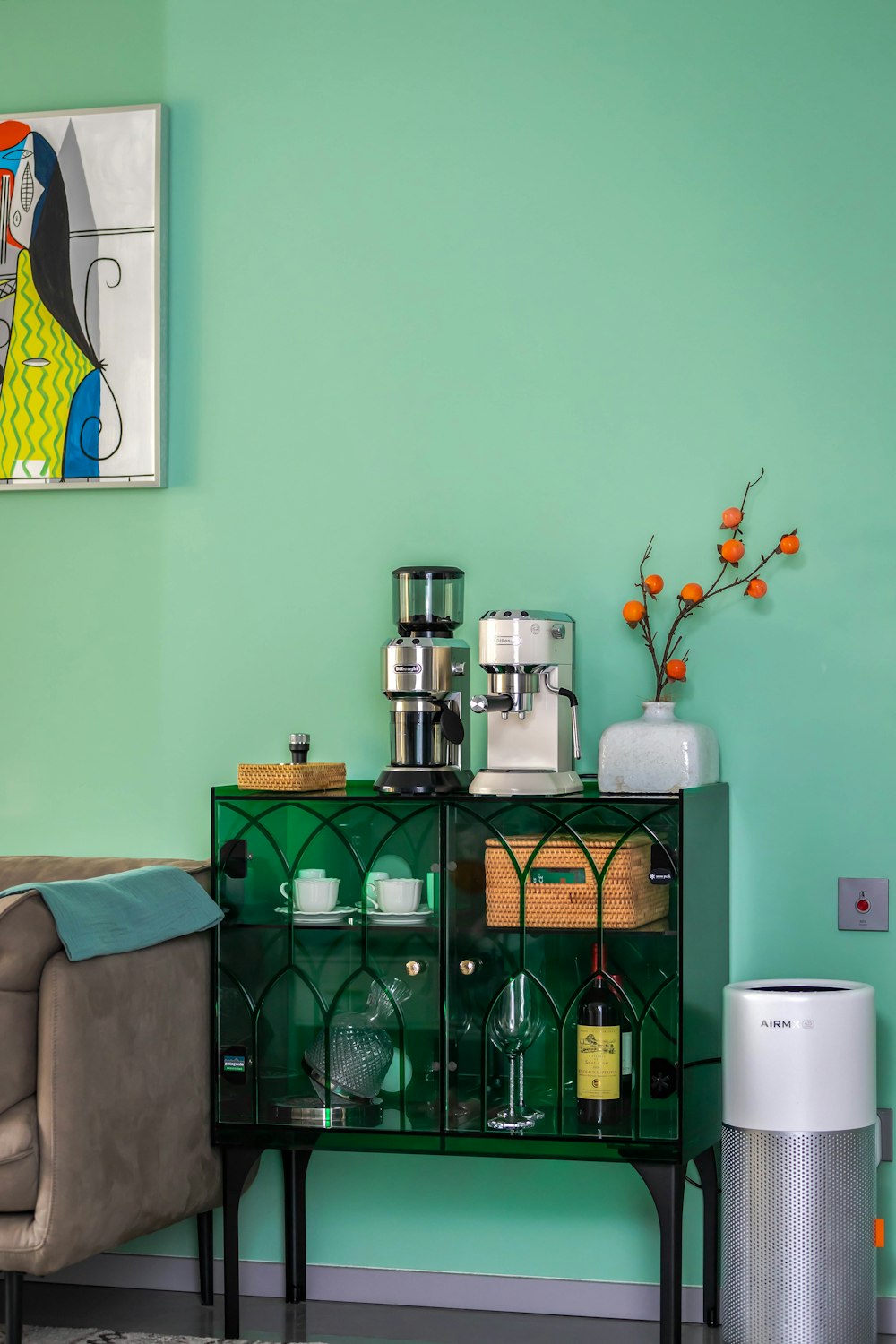 a living room with green walls and furniture