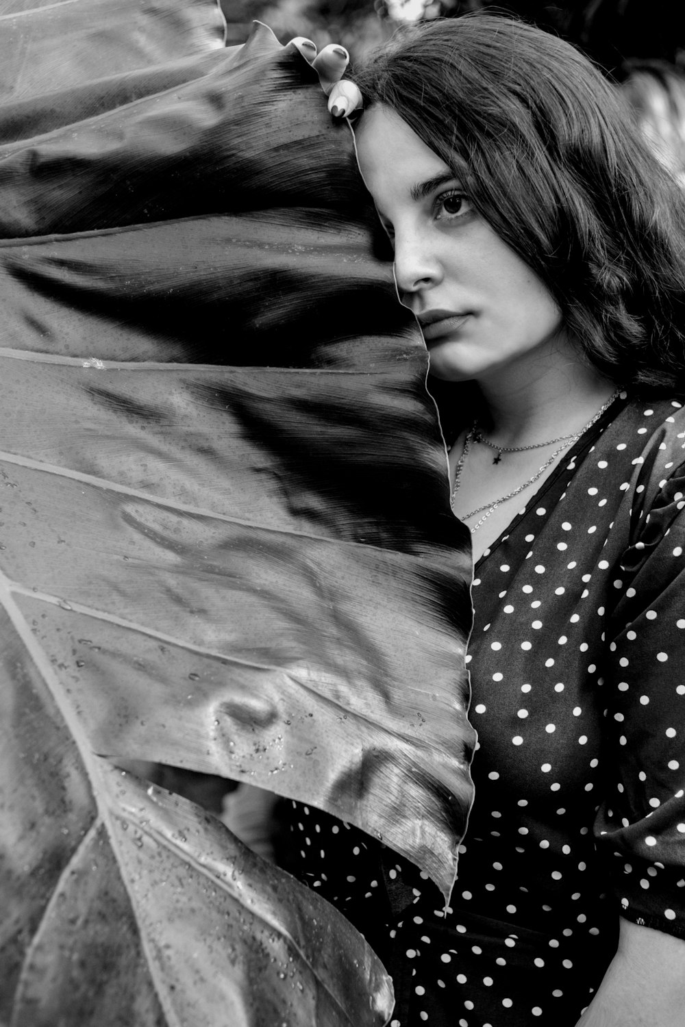 a black and white photo of a woman in a polka dot dress