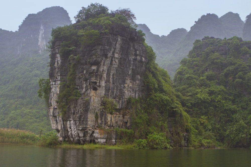 a large rock outcropping in the middle of a lake