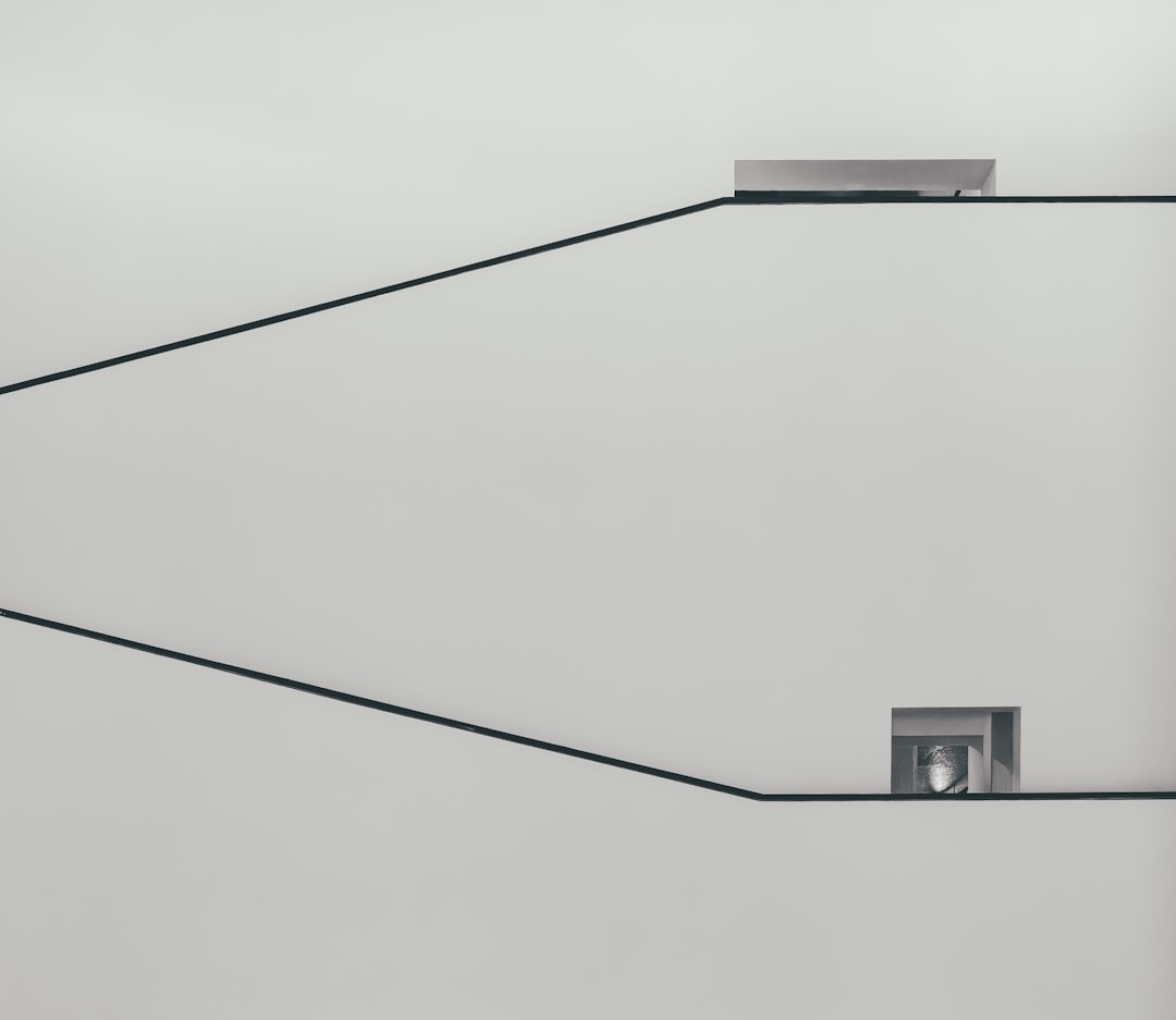 a black and white photo of a square object on a wire, Wall