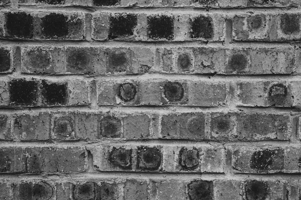 a black and white photo of a brick wall