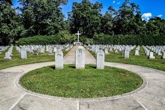 a cemetery with a cross in the middle of it