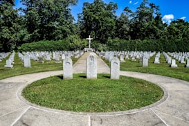 a cemetery with a cross in the middle of it