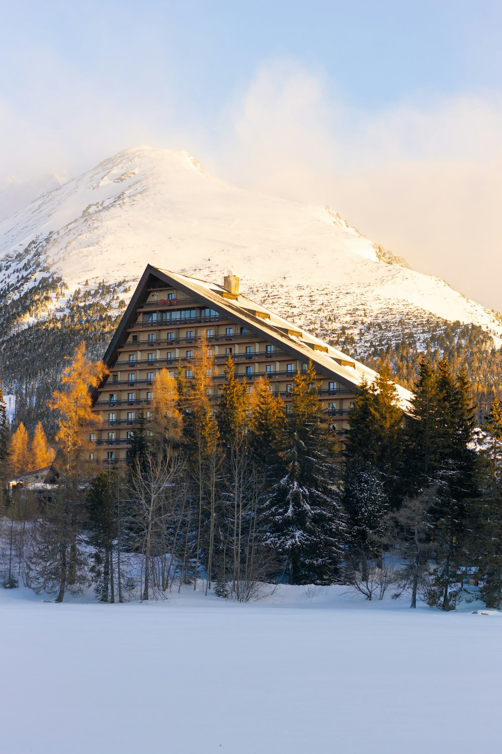 a ski lodge with a mountain in the background
