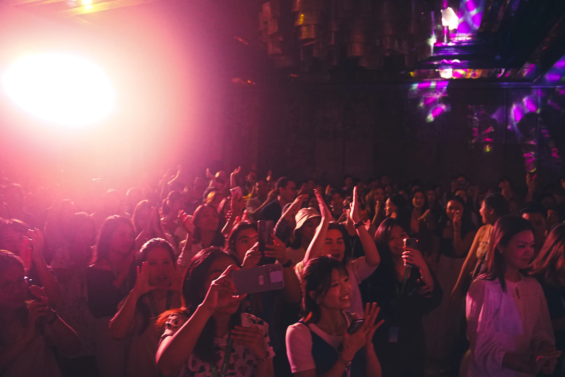 a crowd of people standing around each other at a concert