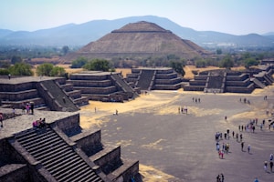 a group of people standing in front of a pyramid